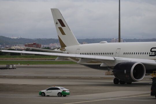 Tail fin and winglet of a Starlux Airlines Airbus A350 airplane on the taxiway.
