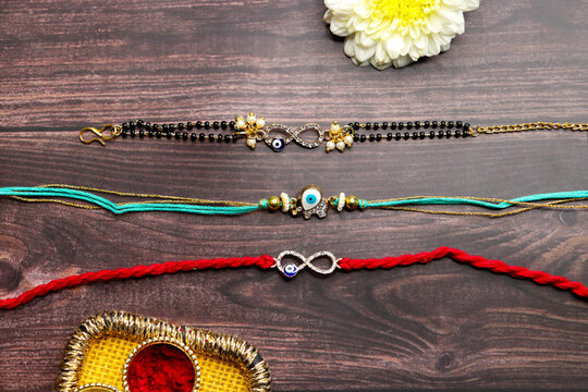 ndian festival Raksha bandhan. Rakhi thali with diya, flowers and tilak with rasmalai. Puja thali for rakhi festival with roli chawal. copy space.