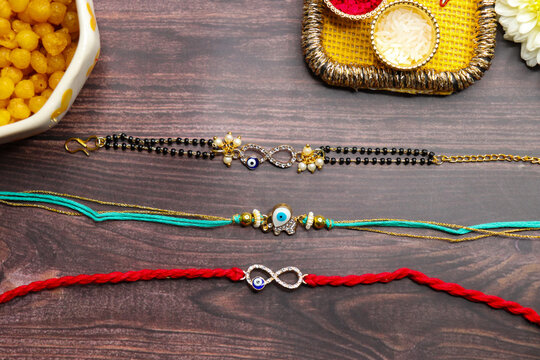 ndian festival Raksha bandhan. Rakhi thali with diya, flowers and tilak with rasmalai. Puja thali for rakhi festival with roli chawal. copy space.