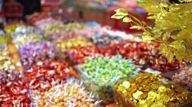 Festive Candy Display in Supermarket with Golden Decorations
