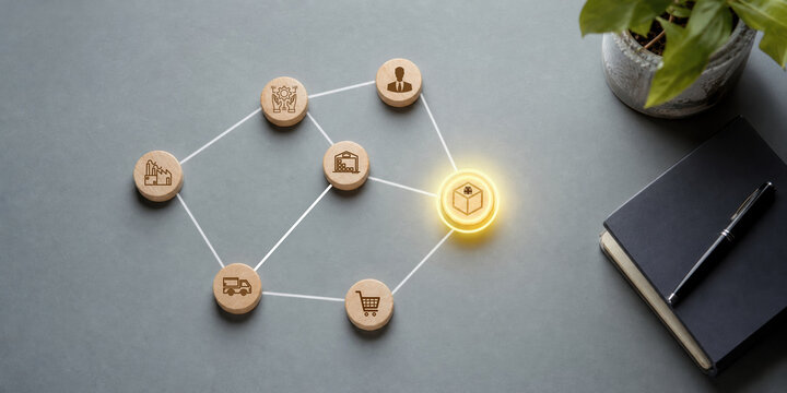 supply chain management logistics risk management. Wooden tokens connected by lines represent logistics and supply chain concepts on a gray surface.