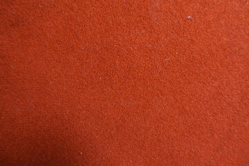 Fototapeta premium Texture of simple reddish orange felt fabric
