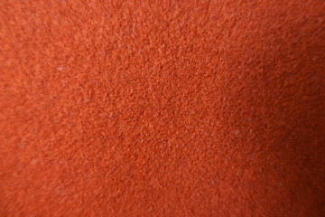 Fototapeta premium Texture of simple reddish orange felt fabric