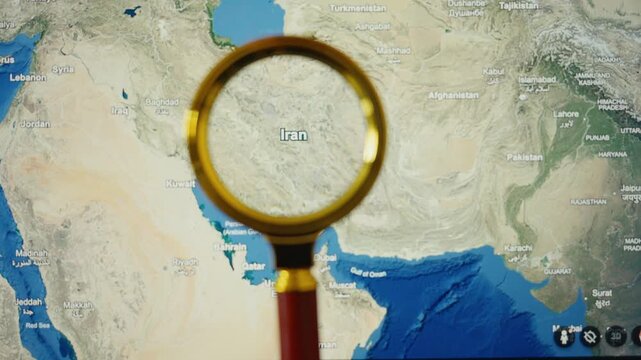 Magnifying glass analyzing iran on world map