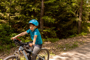 Fototapeta premium Happy children, boys, riding bikes together in a beautiful czech ruralside summer time