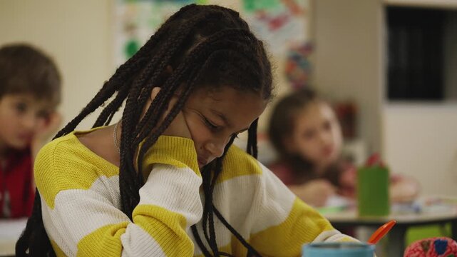Primary school pupils feeling bored while listening to teacher during lesson