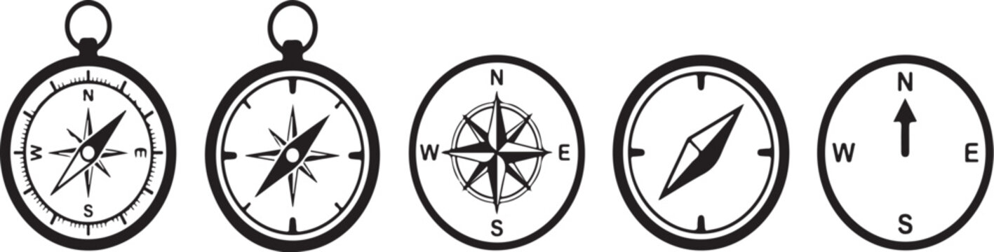 Five navigational compasses isolated on a white background, showing varied designs and markings for orientation.