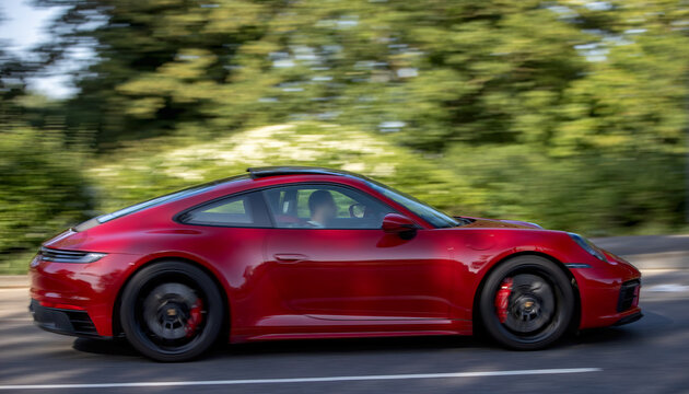 Milton Keynes,Bucks,UK - May 25th 2026:  2022 red Porsche 911 Carrera 4 Gts car driving on a British road