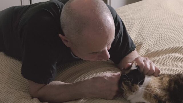heartwarming scene mature man bonding with feline companion, finding comfort in each other's company, Human-animal bond