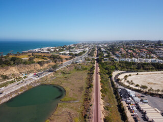 Fototapeta premium Aerial View of Del Mar Coastal Rail Line and Highway 101 Beside San Dieguito Lagoon and Pacific Ocean in Southern California