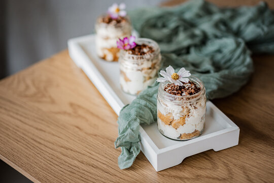 Elegant dessert cups beautifully arranged on a table for a wedding reception or special event. Sweet treats with stylish presentation, perfect for catering, celebrations, and parties.