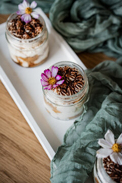 Elegant dessert cups beautifully arranged on a table for a wedding reception or special event. Sweet treats with stylish presentation, perfect for catering, celebrations, and parties.