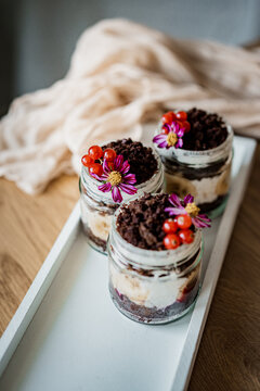 Elegant dessert cups beautifully arranged on a table for a wedding reception or special event. Sweet treats with stylish presentation, perfect for catering, celebrations, and parties.