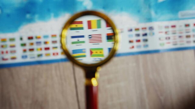 Magnifying glass exploring world flags map
