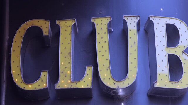 Yellow Led Lights Sign at Club Building Wall Zoom in