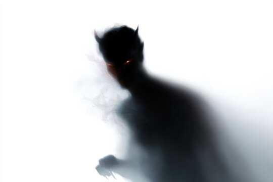 Dark demonic silhouette with ember eyes and smoky form for horror background and dramatic poster design