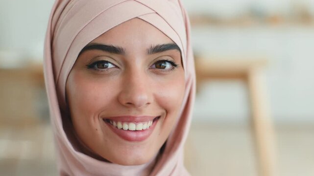 Pensive thoughtful smiling Arabian Muslim woman in hijab thinking looking at camera home happy business female Indian Islamic businesswoman portrait close up working confident lady indoors apartment