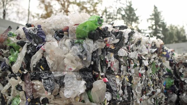 Pressed plastic bottles. Environment. Industry. Landfill of pressed plastic bottles and their recycling. Ecology. Recycling of secondary raw materials.