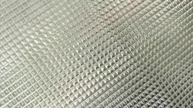 Closeup old vintage glass tile rough surface with retro dots pattern design abstract background texture. Stop motion animation loop.