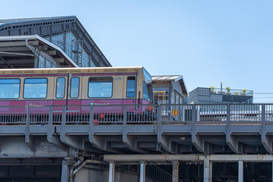 Germany, Berlin May 25, 2026 A vintage cream and red S Bahn train travels on elevated tracks near Friedrichstrasse. Steel girders and station roofs frame the transport scene.