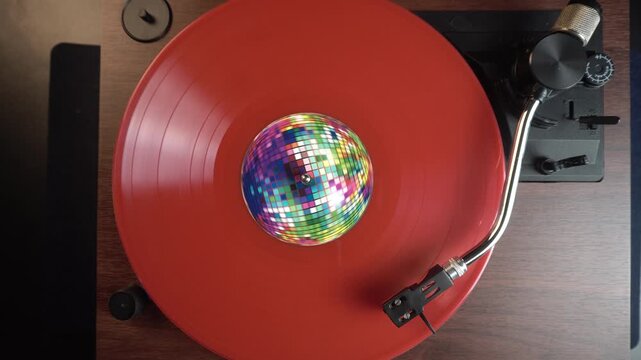 Playback of Red Vinyl Record With Disco Ball Sticker, Vintage Music Collection, Top Down View