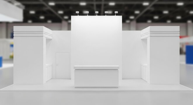 Empty white exhibition stand or trade show booth with a central counter and display walls in a large, blurred hall, ready for branding and customization.