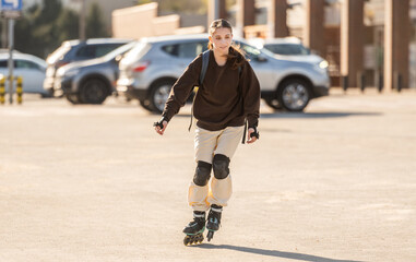 Fototapeta premium Happy Teen Girl Roller Skating In The Parking Lot