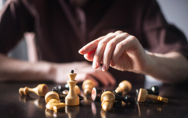 chess piece in female hands on a background © ketrin