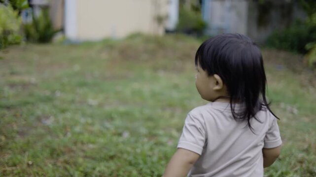 Toddler Exploring The Garden To Gather Kaffir Lime Fruits