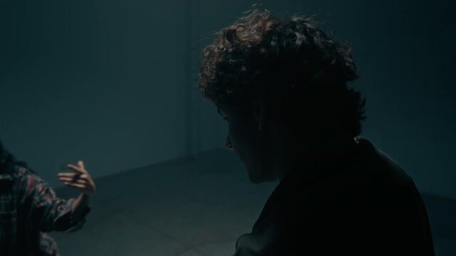 Cinematic shot of hip hop freestyle dance battle with creative young man and woman dancing in dark empty studio captured from immersive perspective, great for commercial use, copy space