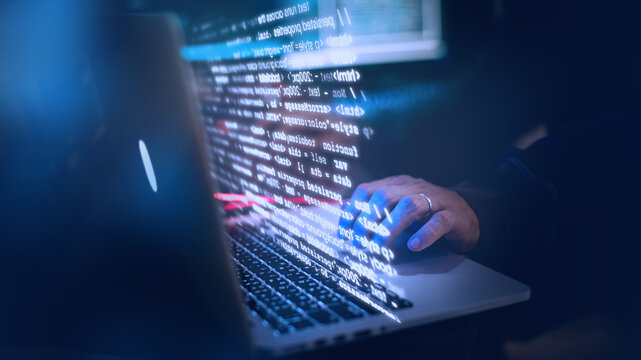 Man using laptop in the dark