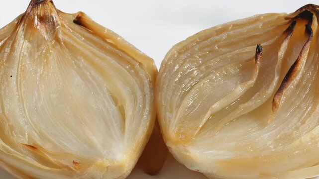Roasted onions on a white plate, zoom out effect