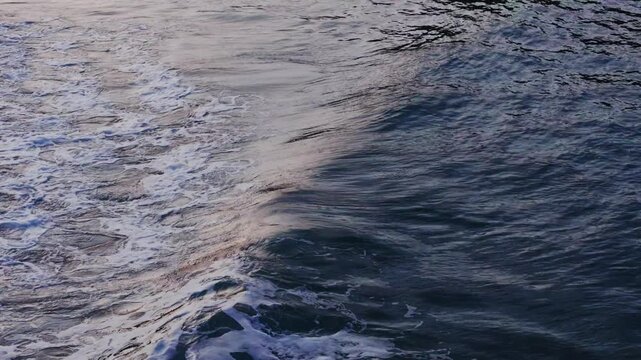 Golden hour light on breaking waves in slow motion