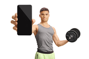 Naklejka premium Young man holding a dumbbell and showing a smartphone with blank screen