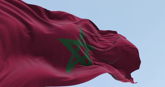 Morocco national flag waving in the wind on a clear day. Red flag with a green pentagram in the center. Seamless 3d render animation. Slow motion loop. Selective focus