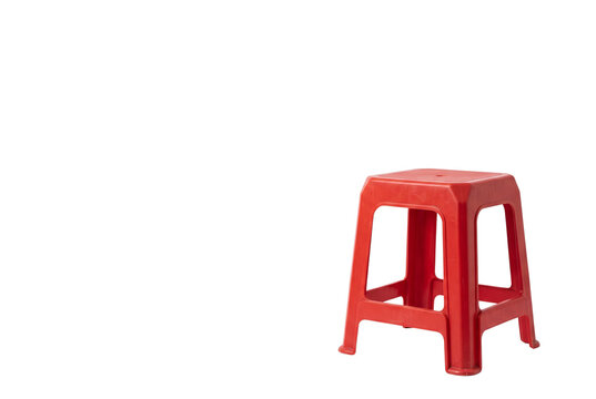 Simple red plastic stool with empty copy space
