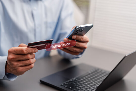 Online subscription service for premium content. Man using smartphone and credit card to pay for exclusive digital membership.