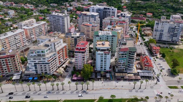 Aerial video  of Vlora coastal hotels, apartment blocks and hillside.