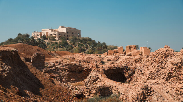 Saddam Hussein Palace overlooking ancient ruins in Iraq under clear blue sky