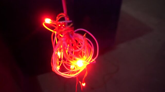 Coiled red LED string light, commonly called fairy or rice light, offering decorative illumination for festivals, celebrations, home d&eacute;cor, parties, and events.