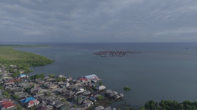 Stilted homes of the Bajau Laut rise gently above turquoise waters, where sea nomads have lived in harmony with the ocean for generations
