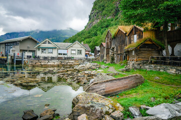 Old traditional houses on the coast of Geirangerfjord in town Geiranger, one of the most beautiful fjords in Norway © Olena Zn