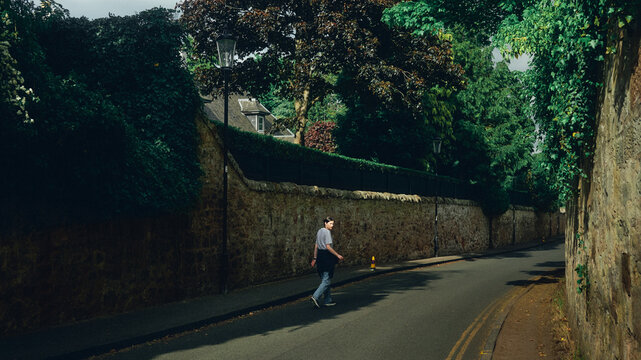 woman walking on the road in the city at sunset