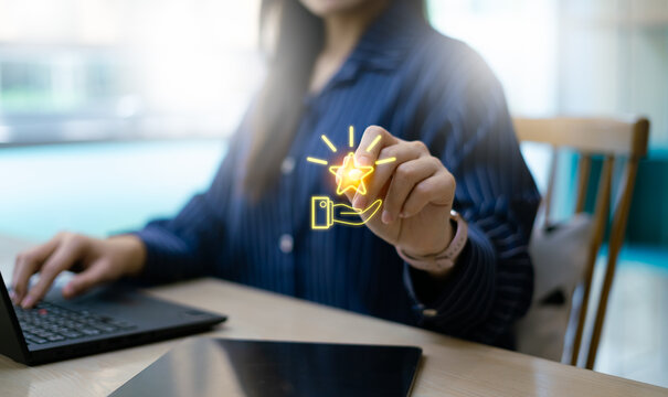 Loyalty rewards and redeem points concept with smartphone app. Close up of woman using mobile phone with glowing star icon for customer privilege, membership bonus, and marketing promotion program