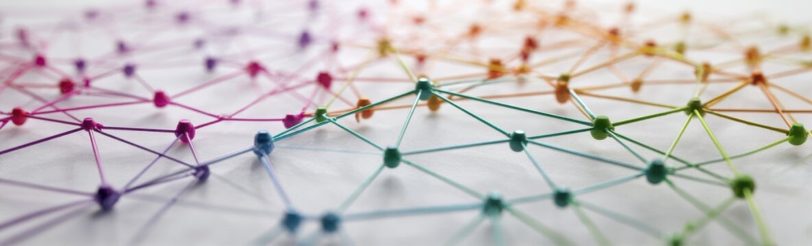 Abstract network of colorful pins connected by threads, representing connections and data flow.