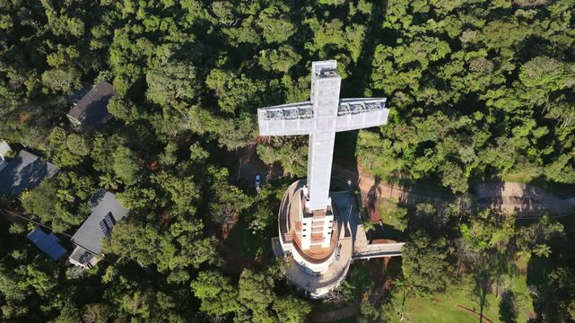 Cinematic drone orbit around Santa Ana Cross inside Parque Tem&aacute;tico de la Cruz in Misiones rainforest.