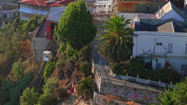 Aerial orbit establishing of the Gervasoni Walkway in Valparaiso, Chile, on a quiet morning with the Concepcion hill funicular