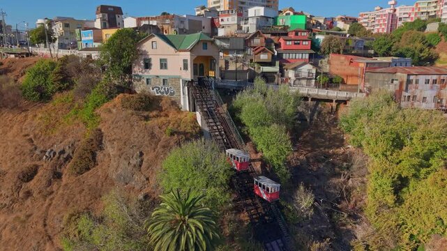 Aerial view dolly in of the Baron Funicular, with its cars going up and down, Valparaiso, Chile