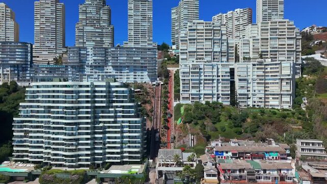 Aerial view dolly in of a private funicular in a modern residential condominium in Concon, Chile, on a sunny day