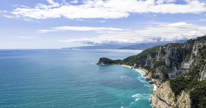 Aerial hyperlapse of stunning cliffs and turquoise water of Ligurian Riviera near Noli, Italy, with clouds moving fast. Copy space